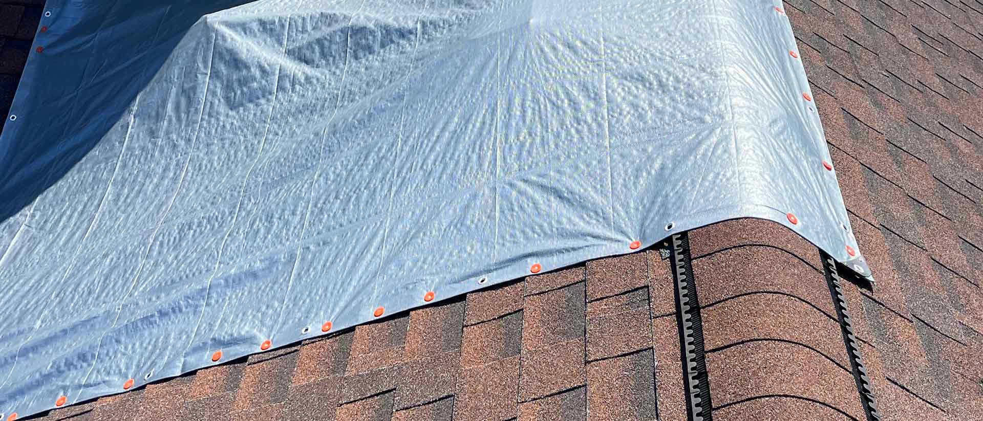 Roof Repair Needed Tarp on Brown Roof